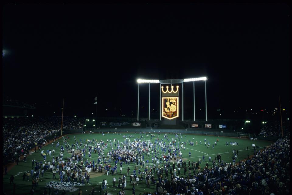 Royals fans rush the field following an 11-0 win in Game 7. (Richard Mackson/SI via Getty Images)