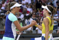 Belgium's Elise Mertens, left, is congratulated by CiCi Bellis of the U.S. after winning their third round singles match at the Australian Open tennis championship in Melbourne, Australia, Saturday, Jan. 25, 2020. (AP Photo/Lee Jin-man)