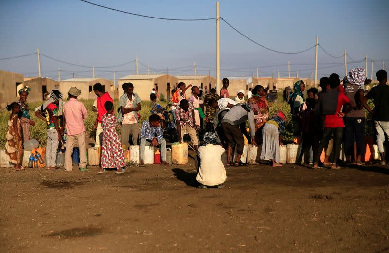 Ethiopian refugees fleeing from the ongoing fighting in Tigray region, queue for water, at the Fashaga camp, on the Sudan-Ethiopia border, in Kassala state