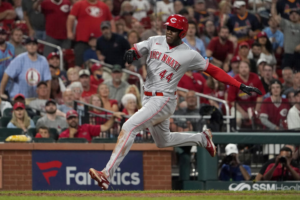 Cincinnati Reds' Aristides Aquino scores during the ninth inning of a baseball game against the St. Louis Cardinals Friday, Sept. 10, 2021, in St. Louis. (AP Photo/Jeff Roberson)