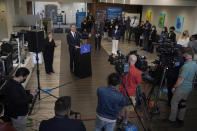 Gov. Gavin Newsom, middle left, speaks at a news conference in Oakland, Calif., Monday, July 26, 2021. California will require state employees and all health care workers to show proof of COVID-19 vaccination or get tested weekly. Officials are tightening restrictions in an effort to slow rising coronavirus infections in the nation's most populous state, mostly among the unvaccinated. (AP Photo/Jeff Chiu)