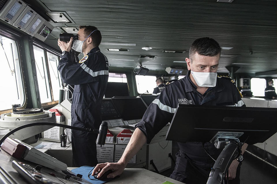 This photo provided Saturday April 10, 2020 by the French Navy (Marine Nationale) shows sailors wearing face masks aboard the French aircraft carrier Charles de Gaulle, Thursday April 8, 2020 in the Atlantic Ocean. France's only aircraft carrier has confirmed 50 cases of the new virus aboard and is heading back to port. Three of those aboard the Charles de Gaulle with the virus have been flown to French hospitals for treatment, the French military said in a statement Friday .The new coronavirus causes mild or moderate symptoms for most people, but for some, especially older adults and people with existing health problems, it can cause more severe illness or death. (Y. Bisson/Marine Nationale via AP)