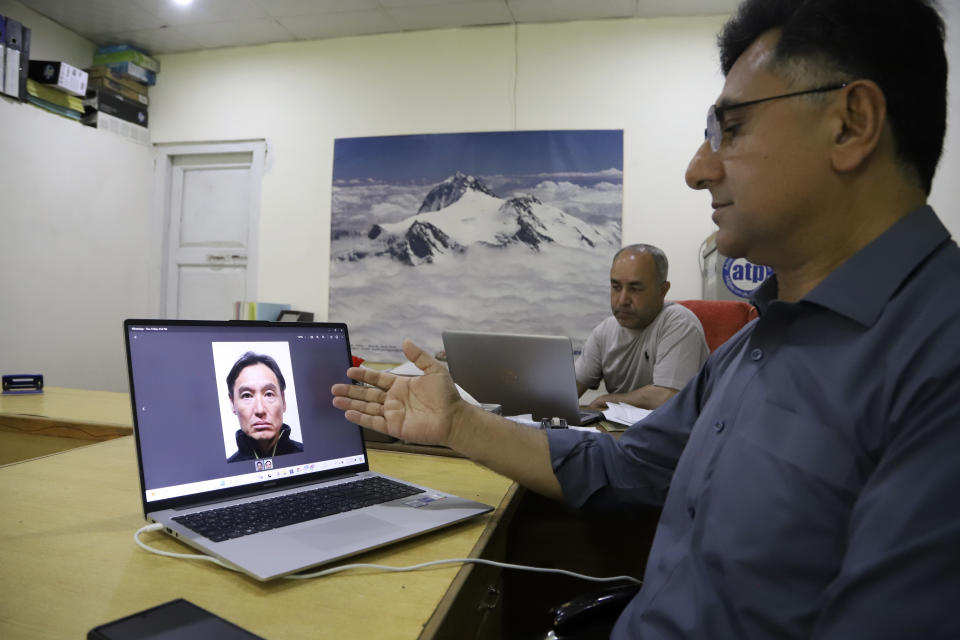 Nizamuddin, manager of Adventure Tours Pakistan, displays a picture of Japanese climber Ryuseki Hiraoka, who had died while he and another climber were scaling the Spantik Peak, also known as Golden Peak, on his laptop at his office in Skardu, Pakistan, Sunday, June 16, 2024. Hiraoka has died while trying to scale one of the highest mountains in northern Pakistan and a search is still underway to find his missing colleague, officials said. (AP Photo/M.H. Balti)