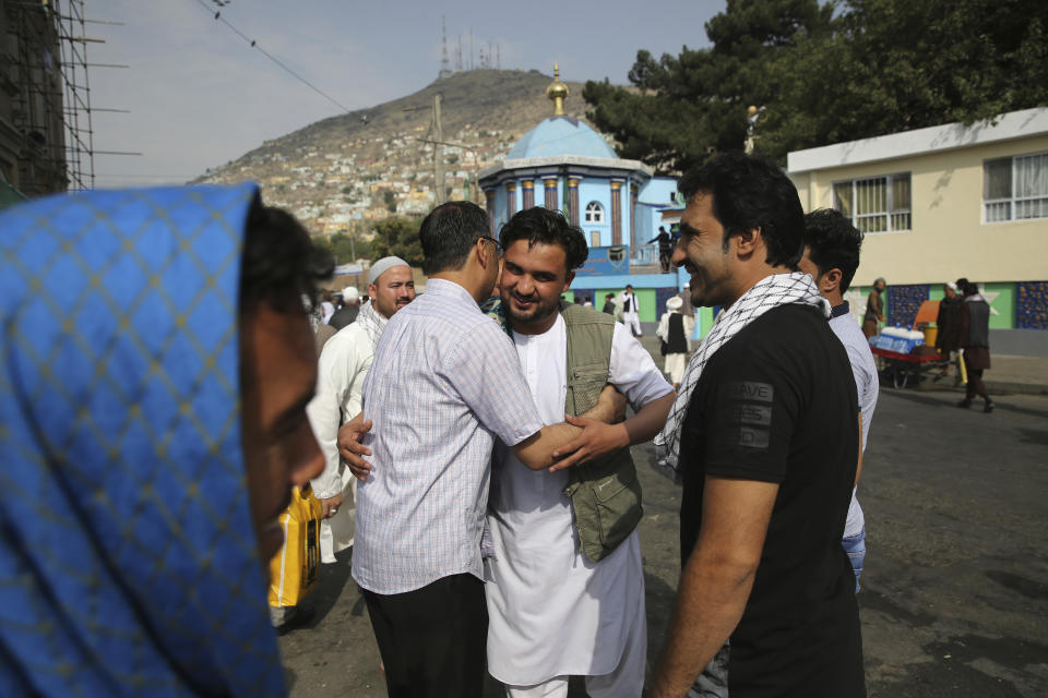 Afghan Muslims greet each other after offering Eid al-Adha prayers in Kabul, Afghanistan, Sunday, Aug. 11, 2019. Muslim people in the country celebrate Eid al-Adha, or the Feast of the Sacrifice by slaughtering sheep, goats and cows whose meat will later be distributed to the poor. (AP Photo/Rafiq Maqbool)