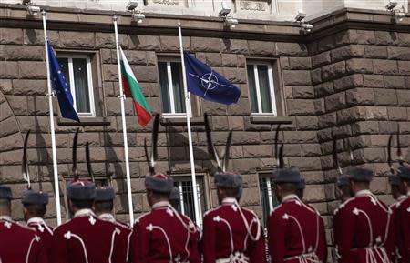 Bulgarian honour guard soldiers attend a flag-raising ceremony as part of celebrations of the 10th anniversary of Bulgaria joining NATO, in front of the Presidency in Sofia April 4, 2014. REUTERS/Pierre Marsaut