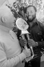 FILE - Pittsburgh Steelers strong safety Donnie Shell, right, accepts the trophy for being named the Steelers' Most Valuable Player, from team vice president and chairman of the board Art Rooney, in Pittsburgh, in this Dec. 16, 1980, file photo. “Chuck Noll had that saying, ‘Whatever it takes’ and Donnie was kind of the definition of that,” Steelers president Art Rooney II said. The hard-hitting cornerback won four Super Bowls during his 14 years in the NFL and next month will become the fifth — and most unlikely — member of the “Steel Curtain” defense to be enshrined in Canton.(AP Photo/Gene Puskar, File)