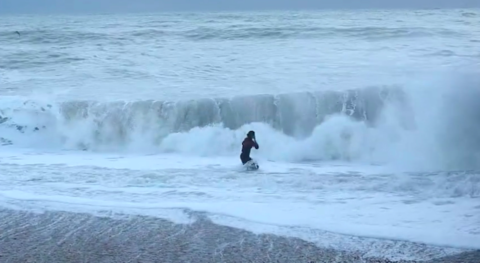 <em>Waves crashed over the woman as she disappeared underneath the water for several seconds (SWNS)</em>