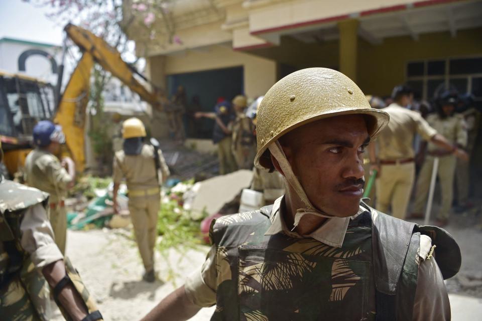 Members of Indian security personnel keep watch during the demolition of the home of Javed Ahmed, a local politician who was allegedly involved in violent protests against the ruling Bharatiya Janata Party (BJP), in                  Prayagraj, Uttar Pradesh, India, June 12, 2022. Officials insist the home was destroyed because it was illegally constructed.  / Credit: SANJAY KANOJIA/AFP/Getty