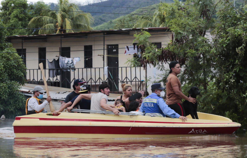 Residents are moved to higher ground after they were rescued from a flooded area in Planeta, Honduras, Thursday, Nov. 5, 2020. The storm that hit Nicaragua as a Category 4 hurricane on Tuesday had become more of a vast tropical rainstorm, but it was advancing so slowly and dumping so much rain that much of Central America remained on high alert. (AP Photo/Delmer Martinez)