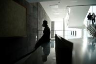 A professor of Pusan National University Park Hyun who used to be a coronavirus patient, takes a deep breath after walking up the stairs at Pusan National University in Busan