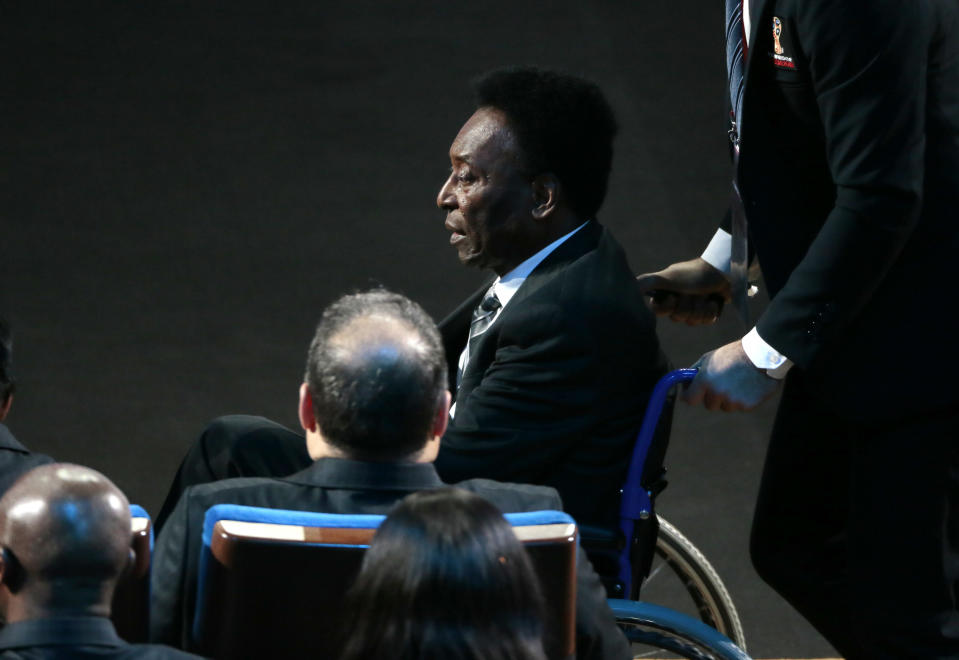 FILE - Brazilian soccer legend Pele is pushed in a wheelchair as he arrives at the 2018 World Cup soccer draw at the Kremlin in Moscow, Dec. 1, 2017. Pelé, the Brazilian king of soccer who won a record three World Cups and became one of the most commanding sports figures of the last century, died in Sao Paulo on Thursday, Dec. 29, 2022. He was 82. (AP Photo/Ivan Sekretarev, File)