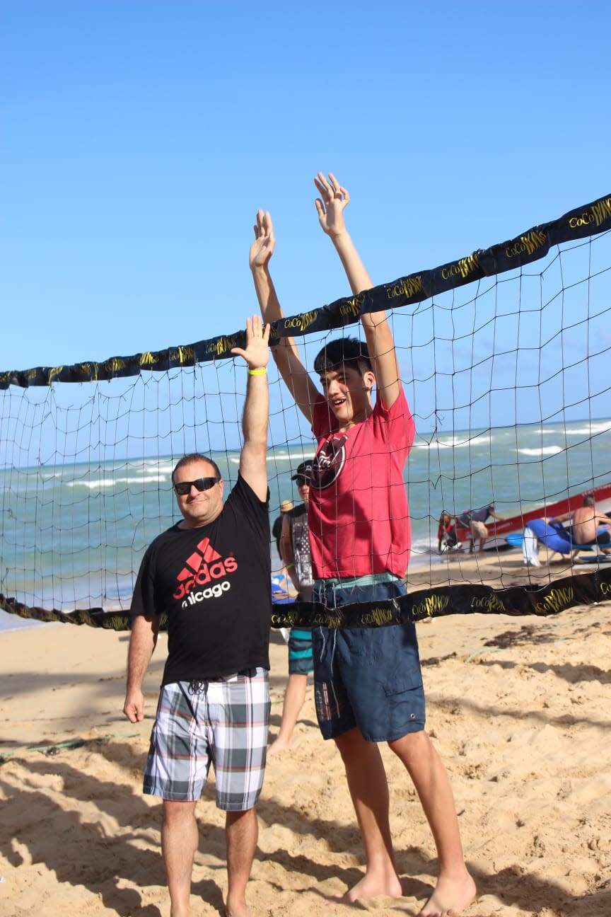 Mike Popik (left) and a younger Zach Edey, now the center for Purdue, getting ready to play beach volleyball