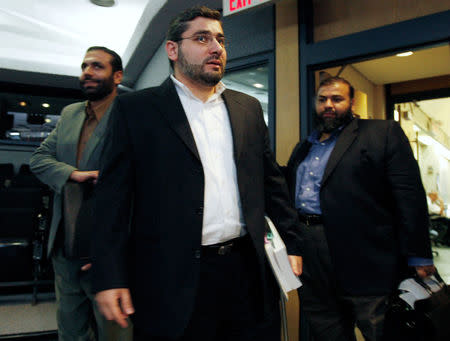 FILE PHOTO -- Muayyed Nureddin (L) arrives for the start of a news conference with Abdullah Almalki (C) and Ahmad El Maati in Ottawa October 21, 2008. REUTERS/Chris Wattie/File Photo