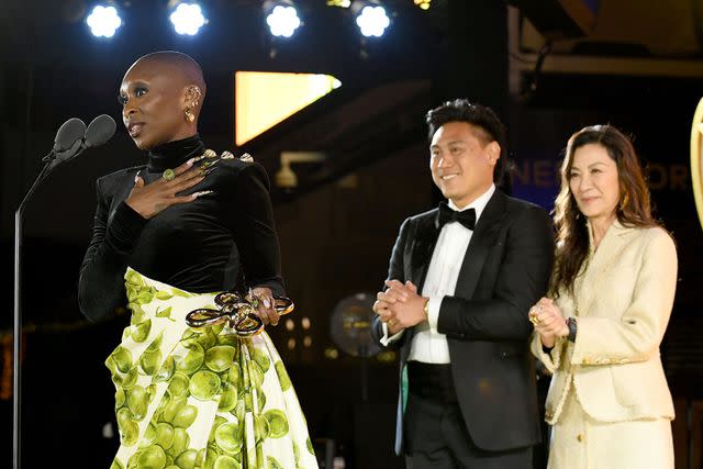 <p>Jon Kopaloff/Getty</p> Cynthia Erivo accepts award from Jon M. Chu and Michelle Yeoh at 2024 Gold Gala