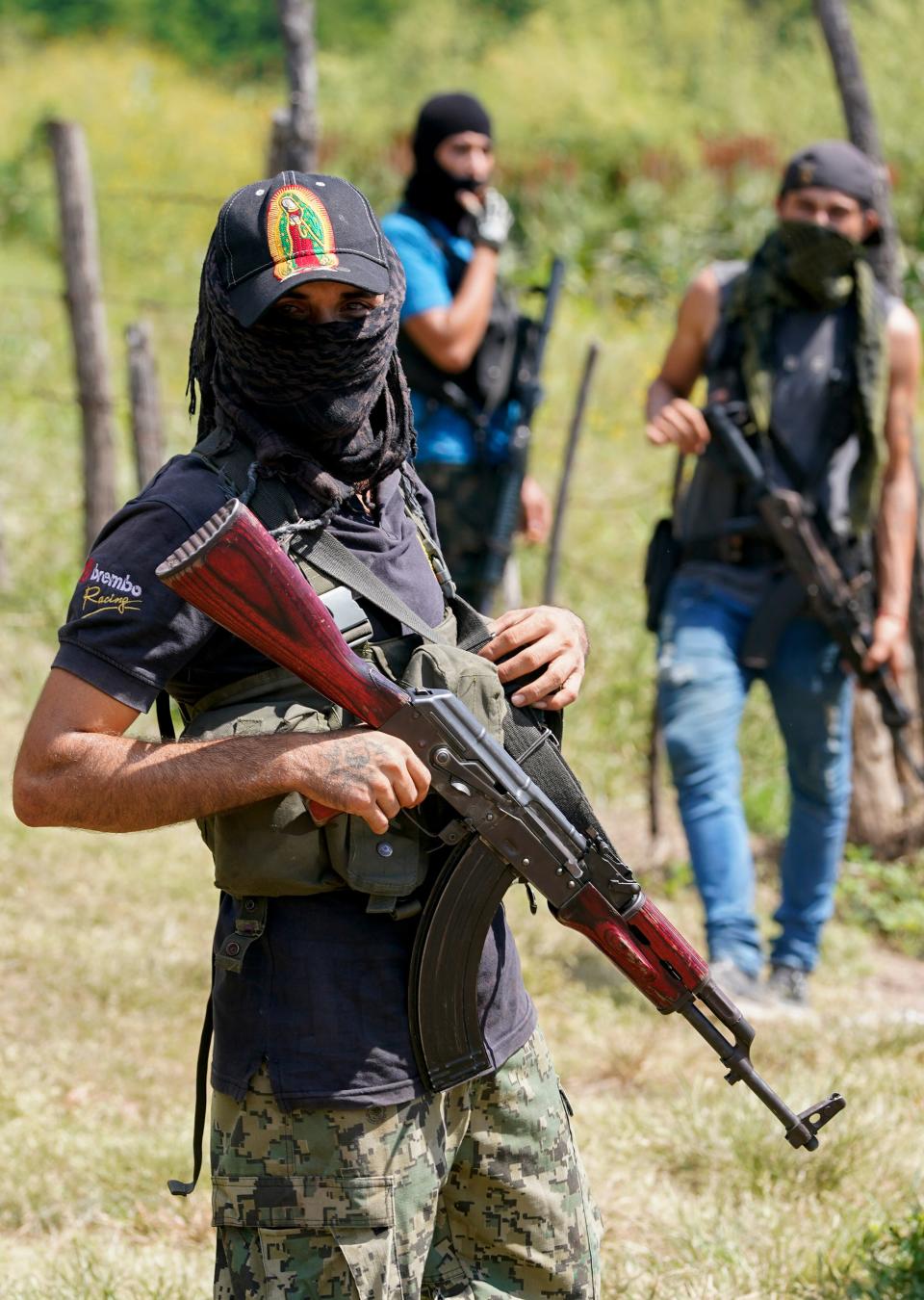 Armed men who claim to be members of a “self-defense” squad patrol the limits of Taixtan, in the Michoacan state of Mexico, Oct. 28, 2021. The army has largely stopped fighting drug cartels here.