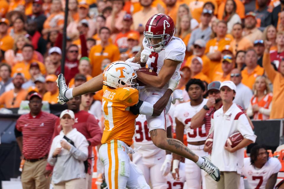 Alabama wide receiver Jermaine Burton (3) catches a pass against Tennessee defensive back Christian Charles (14) during the second half of their 2022 at Neyland Stadium.