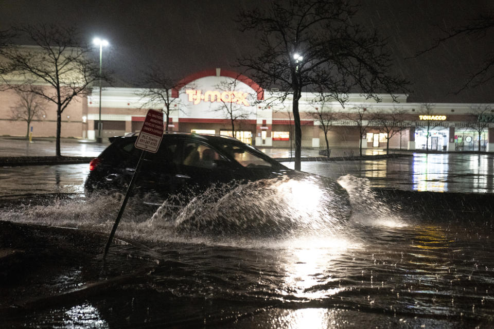 A vehicle drives through a flooded parking lot off of University Avenue in St. Paul, Minn., during severe weather, Wednesday, May 11, 2022. (Renée Jones Schneider/Star Tribune via AP)