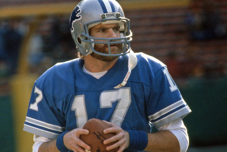 NFL player eric hipple holding a football with helmet and uniform on