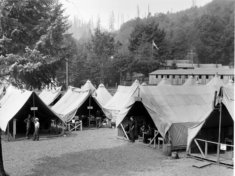 A black and white photo of tents set up in a camp in Washington.