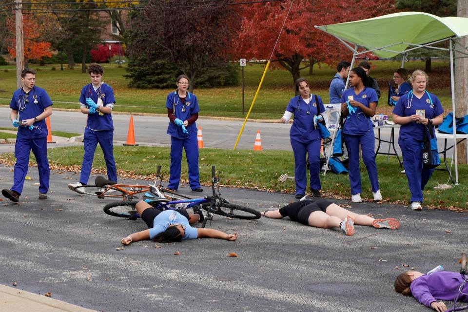 Siena Heights University junior nursing students arrive on the scene of a 25-bike pileup mock emergency Oct. 27 on SHU's Adrian campus. The educational disaster was titled “Tour de Sienna." It required the attention, care and treatment of the nursing students.