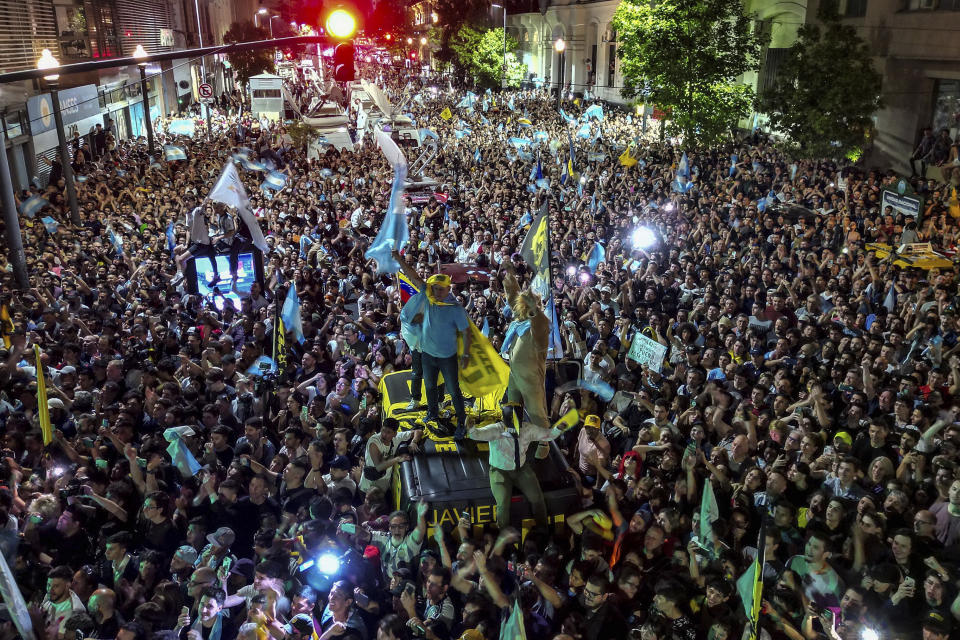 Supporters of presidential candidate Javier Milei celebrate outside his campaign headquarter his victory over Economy Minister Sergio Massa, candidate of the ruling Peronist party, in the presidential runoff election in Buenos Aires, Argentina, Sunday, Nov. 19, 2023. (AP Photo/Matias Delacroix)