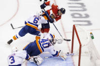 New York Islanders goaltender Semyon Varlamov (40) dives for the save against Florida Panthers center Aleksander Barkov (16), rear right, as New York Islanders defenseman Ryan Pulock (6) and teammate Adam Pelech (3) look on during second period of an NHL hockey game in Toronto, Friday, Aug. 7, 2020. (Chris Young/The Canadian Press via AP)