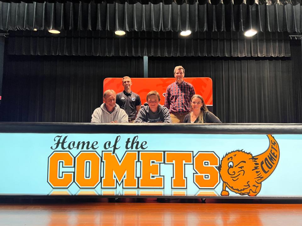 Alan Knowles, joined by his family and coaches, signs with Northwood University.