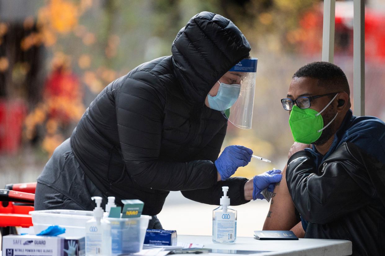 A man gets his COVID-19 vaccination at an outdoor walk-up site in Washington, D.C.