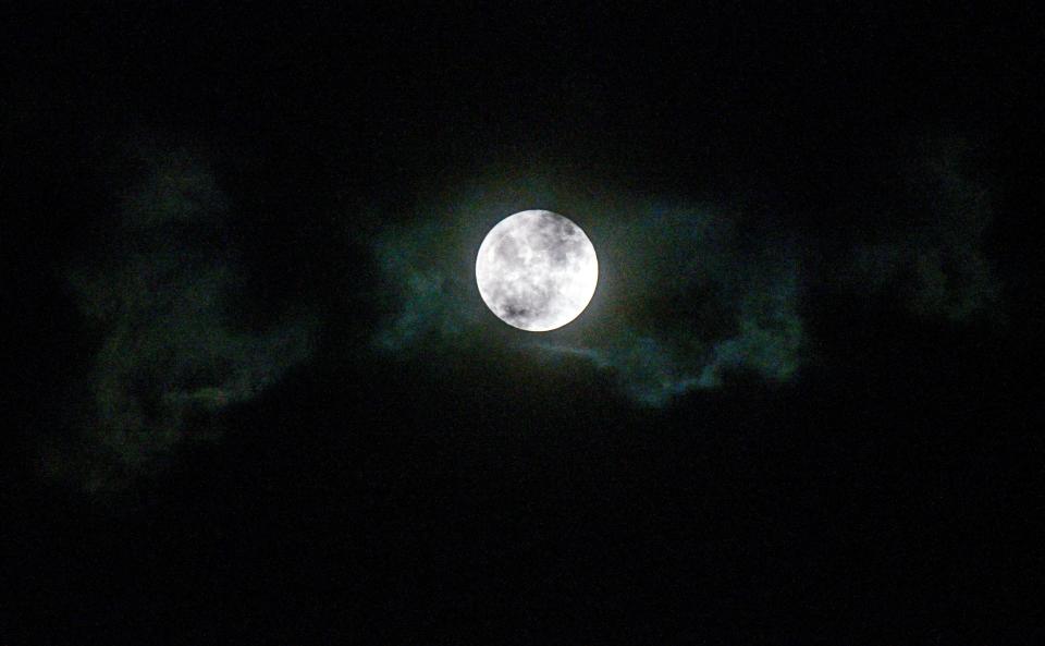 Clouds pass by a full moon, also known as a Blue Moon, on Halloween night, Oct. 31, 2020 over central Illinois.