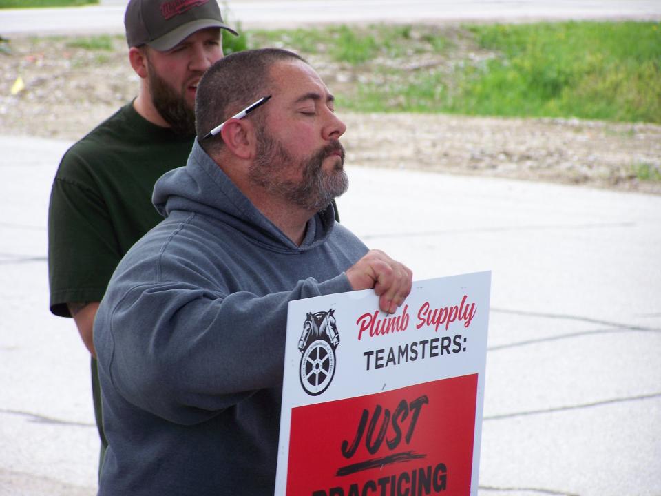 Teamsters member Brent Henderson prepares to picket Plumb Supply in Des Moines on Wednesday as the union seeks a new agreement with the company.
