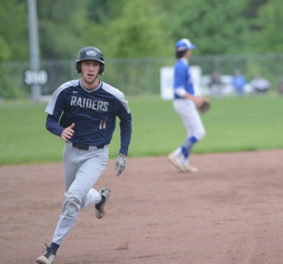 Morgan junior Carson Mummey (11) glides into third base during Tuesday's Division II sectional championship game with Cambridge at Don Coss Stadium.