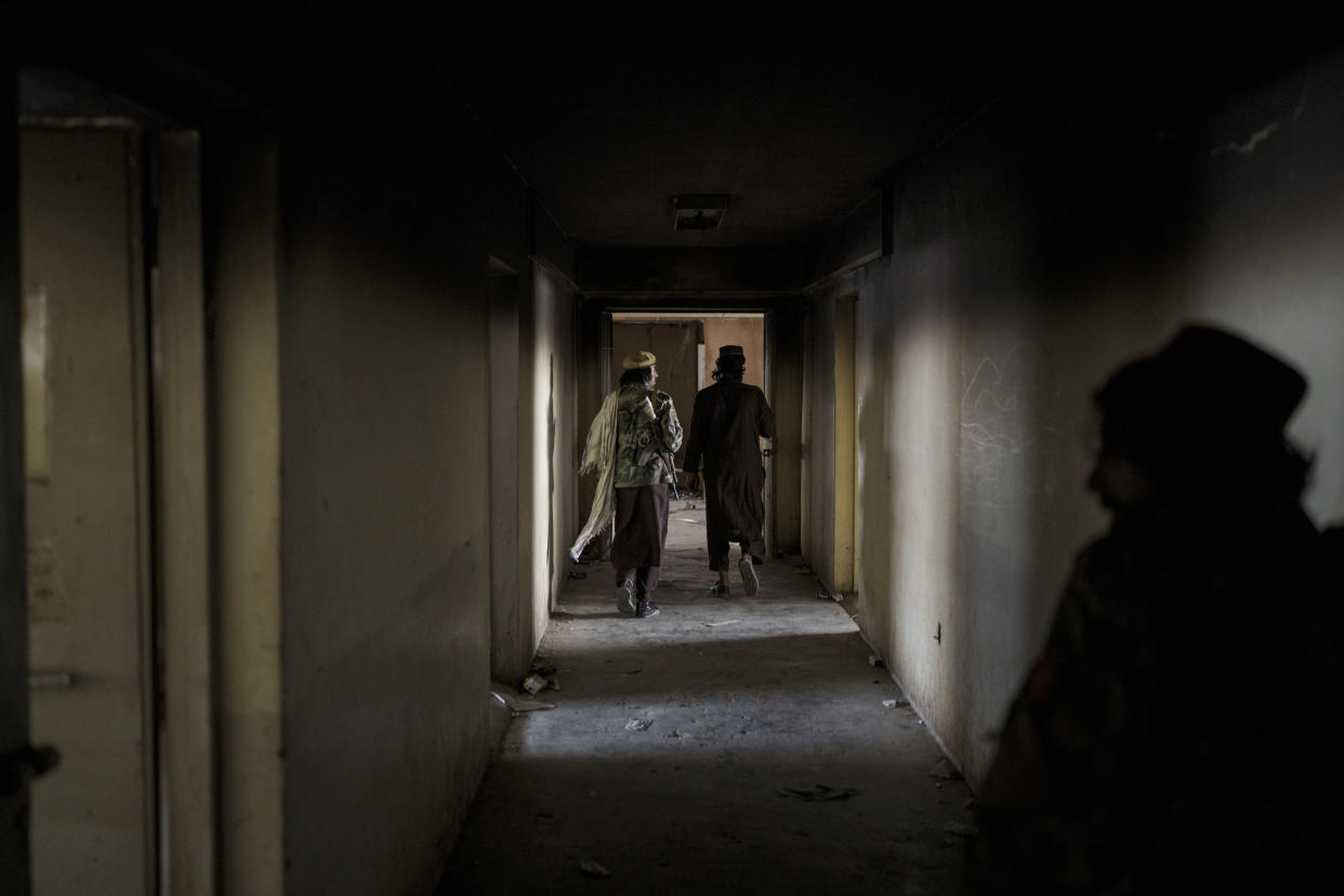 Taliban fighters walk through the alleys of an empty area at the Pul-e-Charkhi prison in Kabul, Afghanistan, Monday, Sept. 13, 2021. Pul-e-Charkhi was previously the main government prison for holding captured Taliban and was long notorious for abuses, poor conditions and severe overcrowding with thousands of prisoners. Now after their takeover of the country, the Taliban control it and are getting it back up and running, current holding around 60 people, mainly drug addicts and accused criminals. (AP Photo/Felipe Dana)