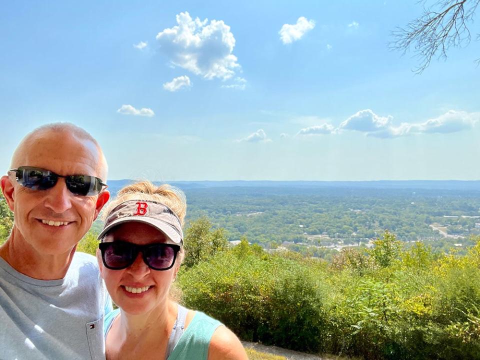 Kara and her husband pose for a selfie while on a hike in Hot Springs National Park.