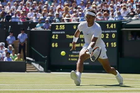 Rafael Nadal of Spain hits a shot during his match against Thomaz Bellucci of Brazil at the Wimbledon Tennis Championships in London, June 30, 2015. REUTERS/Stefan Wermuth