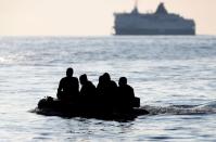 FILE PHOTO: People who say they are from Darfur, Sudan cross the English Channel in an inflatable boat near Dover