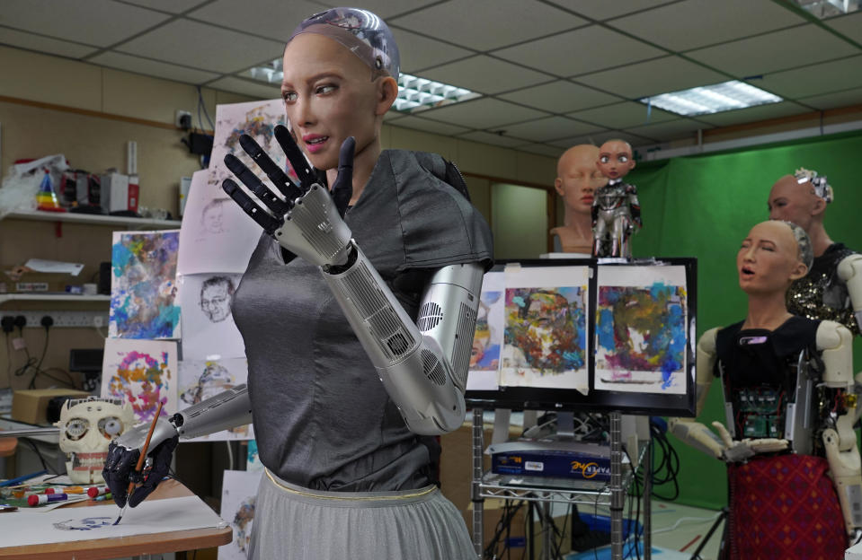 Sophia uses a brush to paint at Hanson Robotics studio in Hong Kong on March 29, 2021. Sophia is a robot of many talents — she speaks, jokes, sings and even makes art. In March, she caused a stir in the art world when a digital work she created as part of a collaboration was sold at an auction for $688,888 in the form of a non-fungible token (NFT). (AP Photo/Vincent Yu)