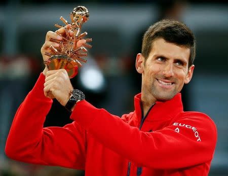 Tennis - Madrid Open - Men's Finals - Novak Djokovic of Serbia v Andy Murray of Britain - Madrid, Spain - 8/5/16 Djokovic holds up the trophy. REUTERS/Paul Hanna