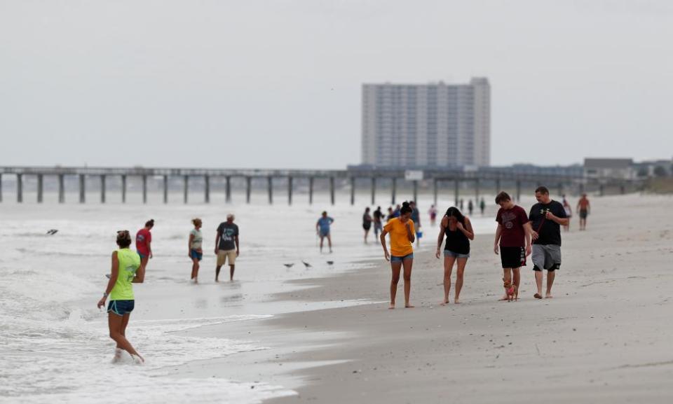 People walk on the beach ahead of the arrival of Hurricane Florence in Myrtle Beach, South Carolina Thursday.