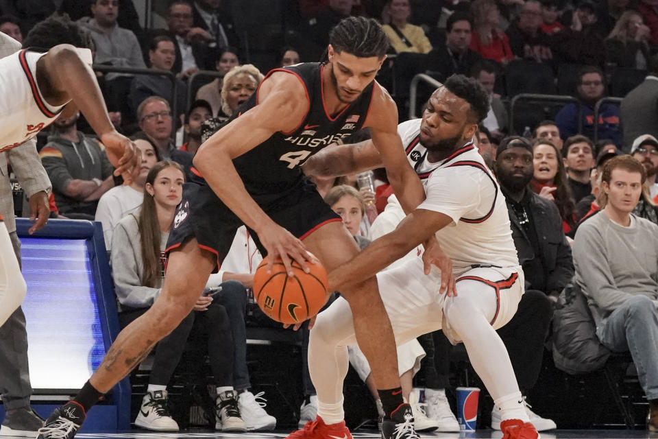 St. John's guard Posh Alexander, right, attempts a steal from UConn guard Andre Jackson Jr., left, during the first half of an NCAA college basketball game, Saturday, Feb. 25, 2023, in New York. (AP Photo/Bebeto Matthews)