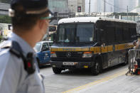 A prison van which a police officer says is carrying Tong Ying-kit arrives at a court in Hong Kong Tuesday, July 27, 2021. Tong, 24, the first person to be tried under Hong Kong's sweeping national security law was found guilty of secessionism and terrorism on Tuesday in a ruling condemned by human rights activists. (AP Photo/Matthew Cheng)
