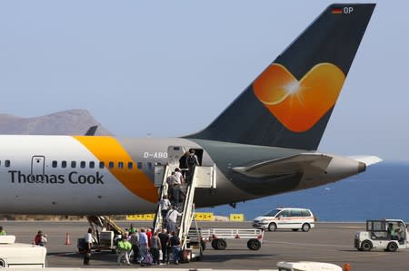 Passengers board a Thomas Cook airplane at the Heraklion airport on the island of Crete