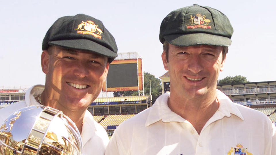 Shane Warne and Steve Waugh pose with a trophy for a photo.