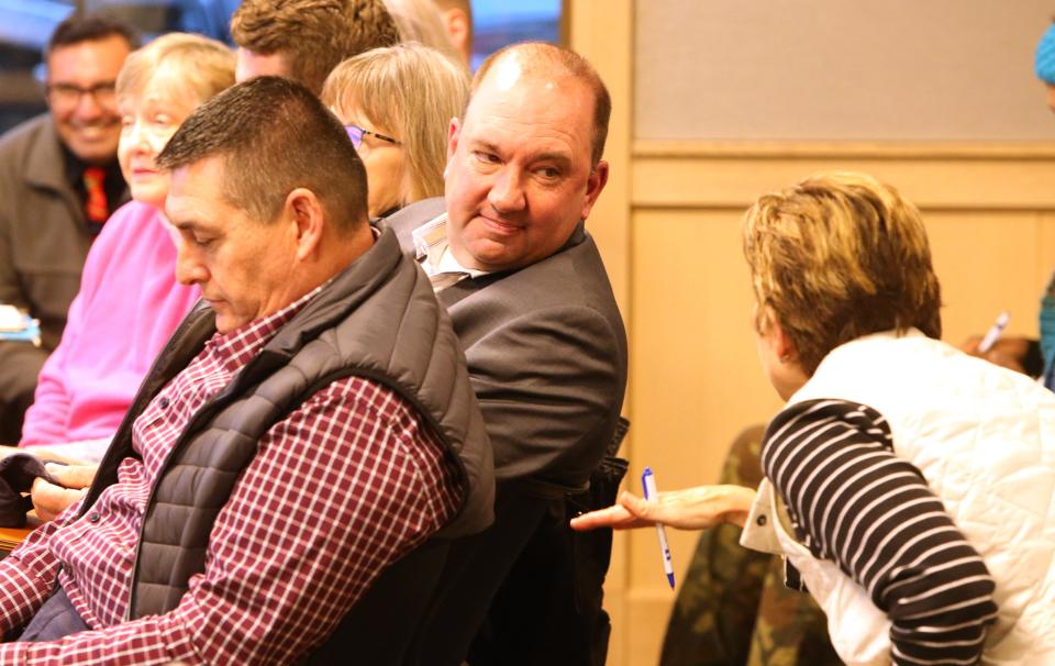 Todd Zeiger, of Indiana Landmarks, listens to county Commissioner Deb Fleming on March 6, 2023, at the Save Portage Manor town hall at the St. Joseph County Public Library in South Bend. He sits next to county council member Mark Catanzarite, foreground, and other Democrats on the council who support efforts to save the home.