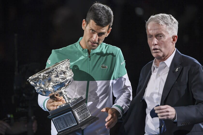 Serbia's Novak Djokovic, left, stands with Australian Open tournament director Craig Tiley.