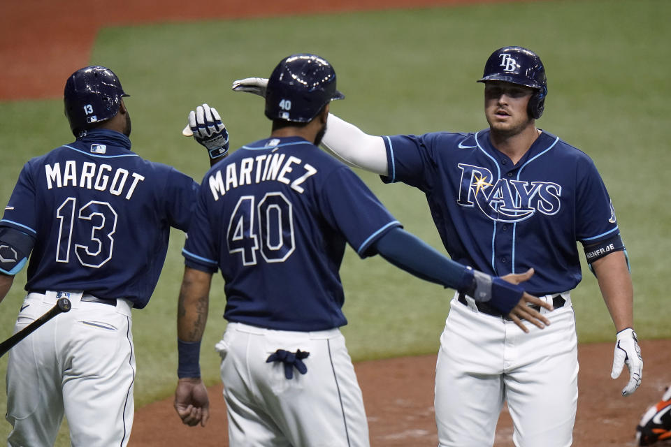 Tampa Bay Rays' Hunter Renfroe celebrates with Manuel Margot (13) and Jose Martinez (40) after Renfroe hit a two-run home run off Baltimore Orioles starting pitcher Tommy Milone during the second inning of a baseball game Tuesday, Aug. 25, 2020, in St. Petersburg, Fla. (AP Photo/Chris O'Meara)