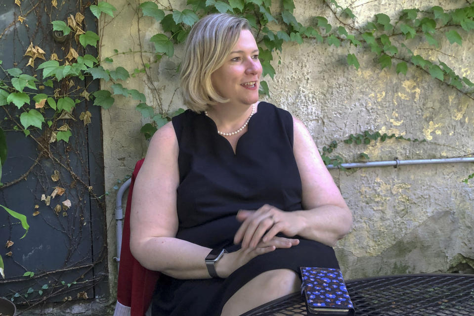 In this photo made on July 29, 2020, Dayton Ohio Mayor Nan Whaley, sits in the outdoor patio of the Trolley Stop restaurant in Dayton, Ohio, and talks about her city's plans for marking the 1-year anniversary of the Aug. 4, 2019 mass shooting. The restaurant is in the entertainment district where it happened. (AP Photo/Dan Sewell)