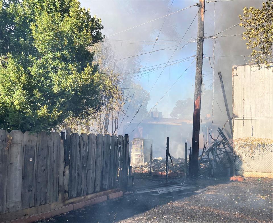 A fire burned multiple structures off School Street near Enterprise High School in Redding on Tuesday, July 18, 2023.