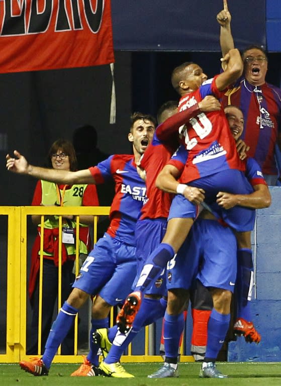 Levante's forward Deyverson (TopR) celebrates his goal with teammates during a Spanish league football match against Villarreal at the Ciutat de Valencia stadium in Valencia on October 4, 2015