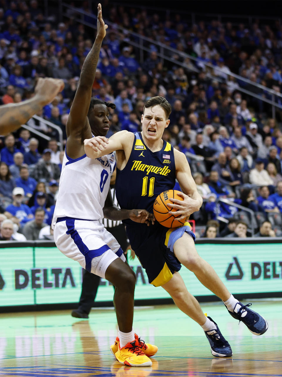 Marquette guard Tyler Kolek (11) drives to the basket against Seton Hall guard Kadary Richmond (0) during the first half of an NCAA college basketball game in Newark, N.J., Saturday, Jan. 21, 2023. (AP Photo/Noah K. Murray)