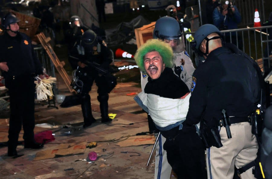LOS ANGELES, CALIFORNIA – May 2: Police officers arrest a pro-Palestinian protester after an oder to disperse was given at UCLA early Thursday morning. (Wally Skalij/Los Angeles Times via Getty Images)